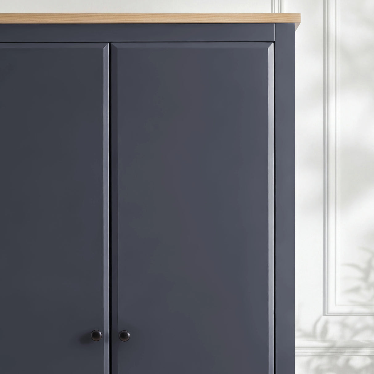[Blue] Haven wardrobe corner detail, blue painted door panels meeting warm oak top and black knob