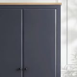 [Blue] Haven wardrobe corner detail, blue painted door panels meeting warm oak top and black knob