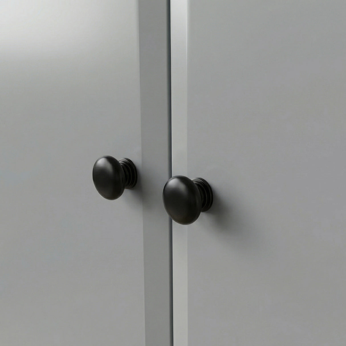 [Grey] Haven wardrobe knob close up, two round black wooden knobs on smooth grey painted doors