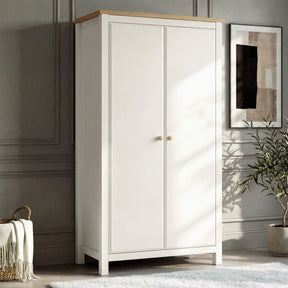 [White] Haven 2 door wardrobe angled, white painted frame with oak top and round oak knobs beside a wicker basket