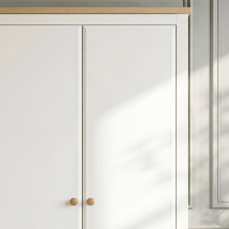 [White] Haven 2 door wardrobe close up of the oak top strip, white door fronts and round wooden knobs below