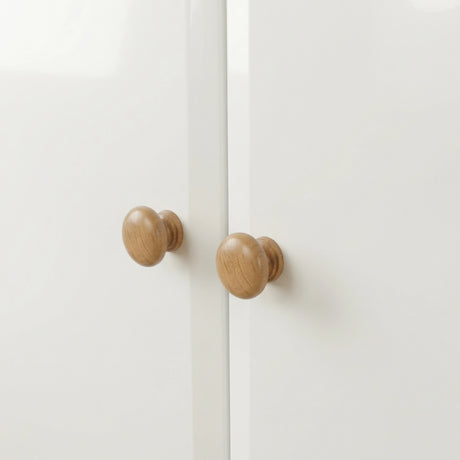 [White] Haven 2 door wardrobe knob detail, turned oak handles sitting centrally where the two white doors meet