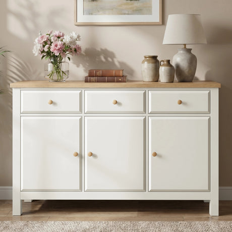 [White] Haven 3-door sideboard front view in a styled room with decorative accessories on oak veneer top