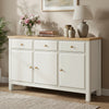 [White] sideboard with wooden top in a room setting with decor items