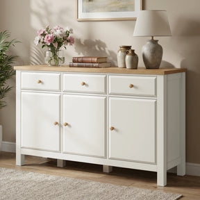 [White] sideboard with wooden top in a room setting with decor items