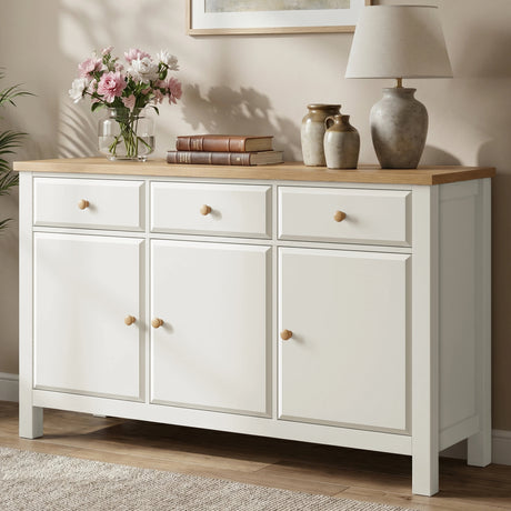 [White] sideboard with wooden top in a room setting with decor items