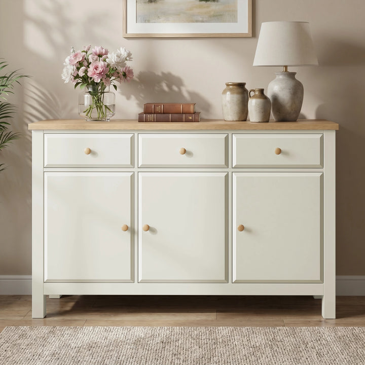 [White] sideboard with wooden top in a room setting with decor items