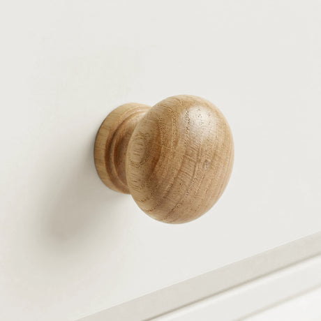 [White] Haven 3-drawer chest close-up of a single round wooden knob handle on a painted drawer front