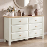 [White] 6 drawers dresser with wooden top against a beige wall with decorative items
