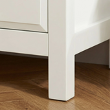 [White] Haven 3-drawer chest angled close-up showing painted frame leg detail and base against a wooden floor
