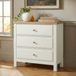 [White] Haven 3-drawer chest front view beside a window with plant and stacked books on oak veneer top