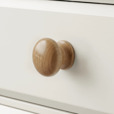 [White] Haven chest of drawers close-up of a single round solid wood knob handle on a painted drawer front
