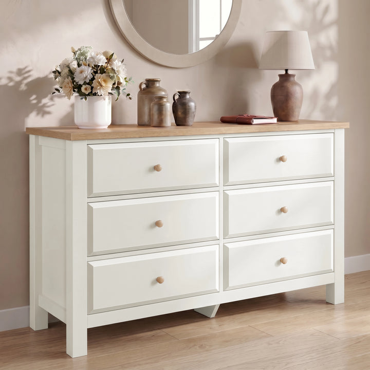 [White] Haven chest of drawers front view from low angle in a neutral room with dried floral arrangement on top