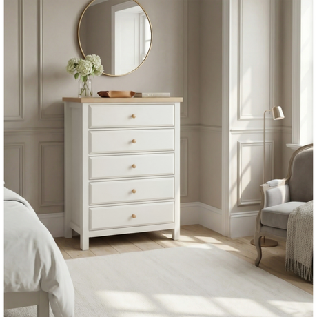 [White] Haven 5-drawer tall chest in a bedroom setting with round mirror and soft furnishings in the background