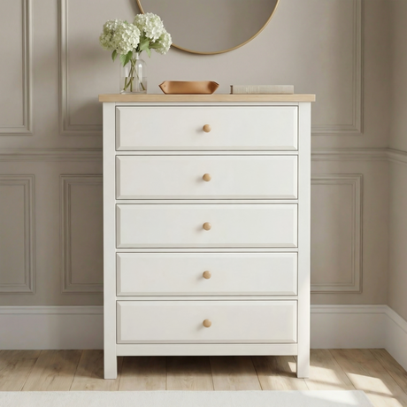 [White] Haven 5-drawer tall chest front view in a styled room with round mirror and flower arrangement on oak top
