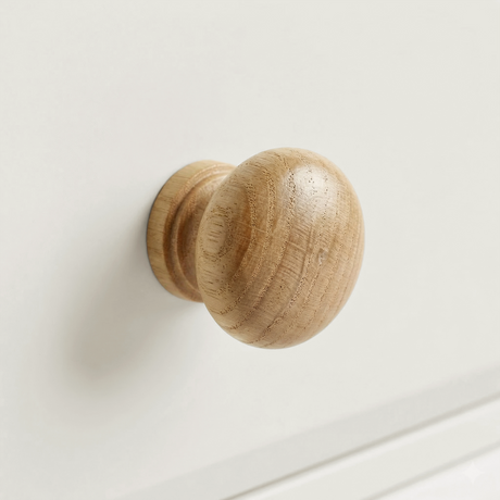 [White] Haven 5-drawer tall chest close-up of a round solid oak wooden knob handle on a painted drawer front