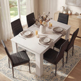 Top view of white dining table with black PU leather chairs set for 6. A stylish and space-efficient dining furniture solution.