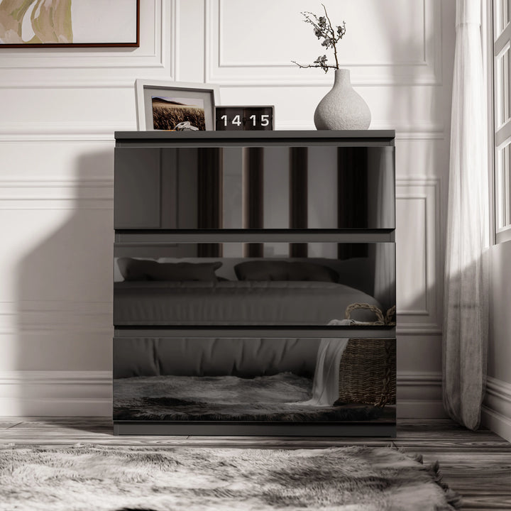[Black] high gloss 3 drawer chest of drawers shown front-on with white vase and clock styled on the surface