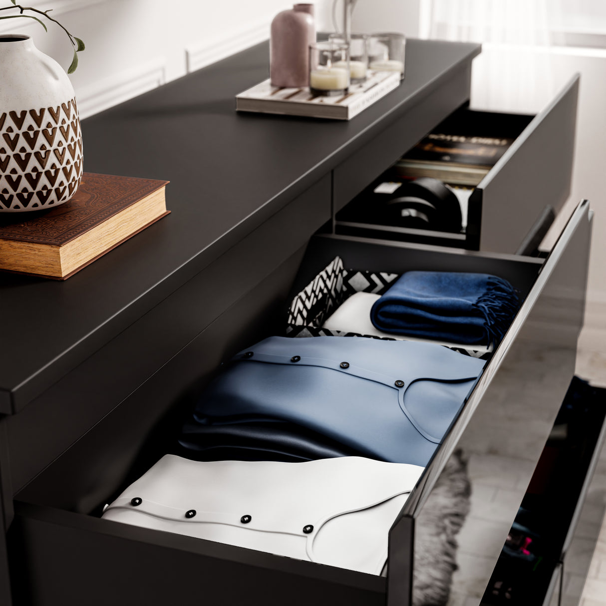 High Gloss Wide 8 Drawer Chest of Drawers in black finish with open drawers showing neatly folded clothes and organized bedroom storage.