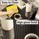 Black high gloss LED side table with easy-to-clean surface, shown with a cloth and coffee cup for practical use.