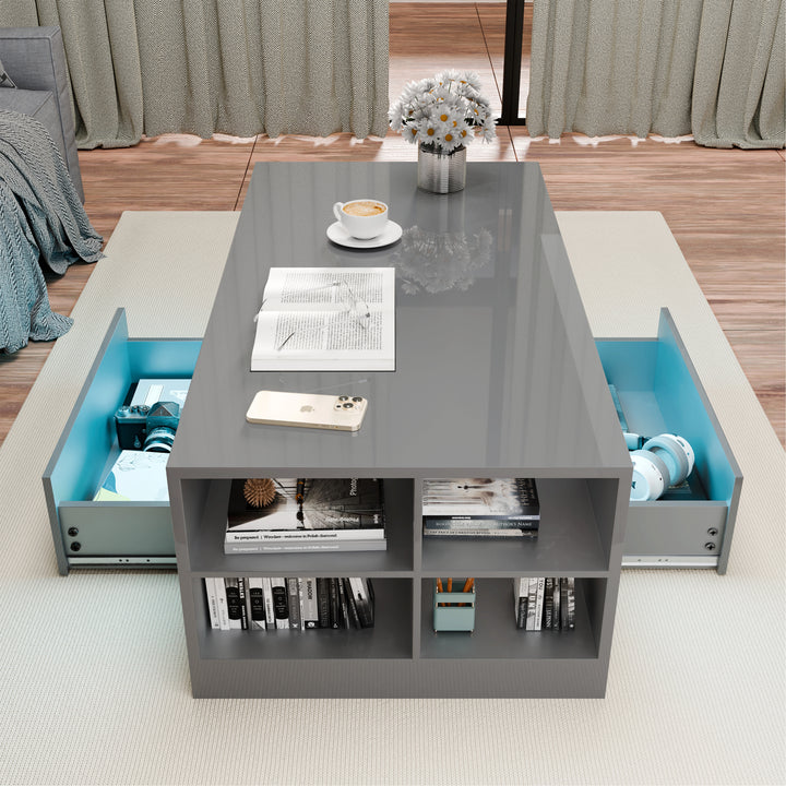 [Grey] top-down shot of grey coffee table with two drawers extended and books in side cubbies