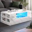 [White Marble] White marble coffee table between dark sofas, blue LED illuminating centre shelf with books on top