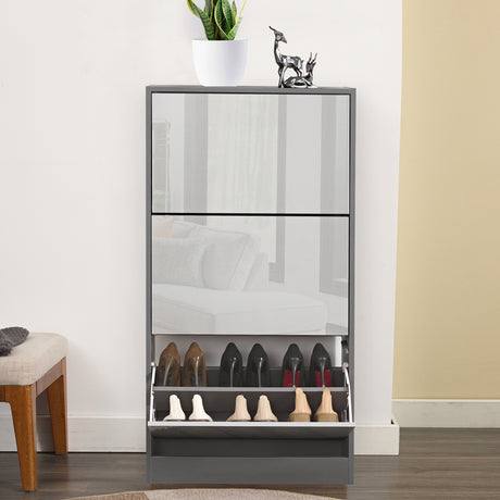 Front view of wooden shoe cabinet with bottom drawer open, showing multiple shoes stored inside.