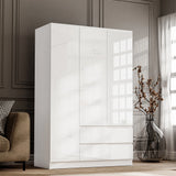 high gloss three-door white wardrobe with drawers placed against a wall near a large window, subtly reflecting natural light