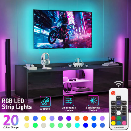 Modern entertainment console with RGB LED strip lights and remote control, featuring a motorcycle video game on TV.
