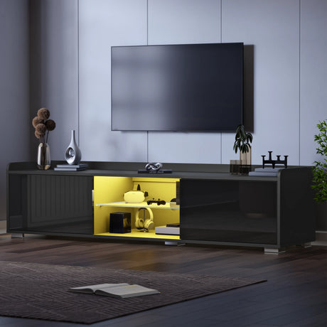 Modern black entertainment console with open cabinet revealing yellow interior, mounted TV above.