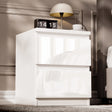 High Gloss 2 Drawer Bedside Table in white with modern design, placed beside a bed with a lamp, clock, and cup on top. Ideal for bedroom storage.