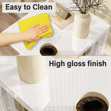 Easy-to-clean high gloss white surface on LED sofa side table, shown with a yellow cloth and coffee cup for practical use.