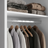 [High Gloss White] Torvek wardrobe interior close-up of chrome hanging rail with shirts and upper shelf with folded knits