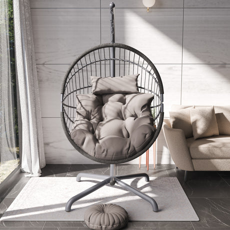 Indoor hanging egg chair with beige cushions, sturdy frame, and cozy modern design.