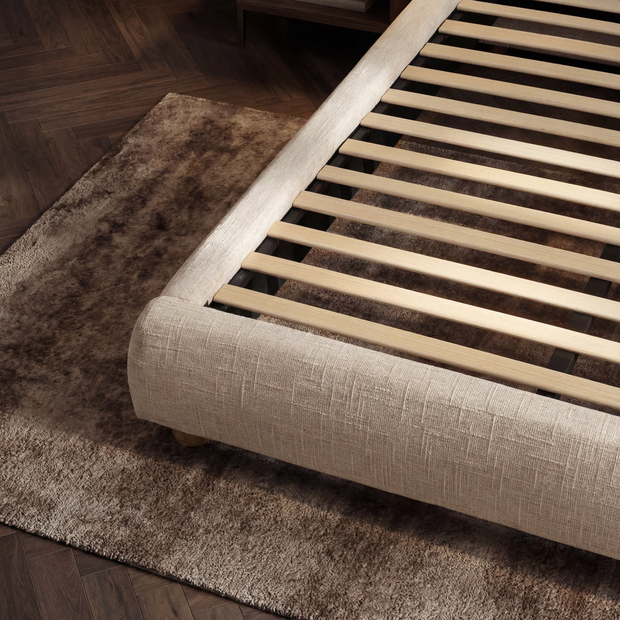 Detailed view of the bed base with evenly spaced wooden slats designed to support the mattress structure