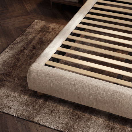 Detailed view of the bed base with evenly spaced wooden slats designed to support the mattress structure