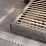 Detailed view of the grey bed base with evenly spaced wooden slats designed to support the mattress structure