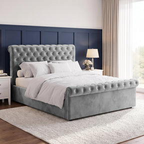 [King | Grey] Angled bedroom view with tufted headboard, rolled footboard, white bedding, bedside tables, and tall window