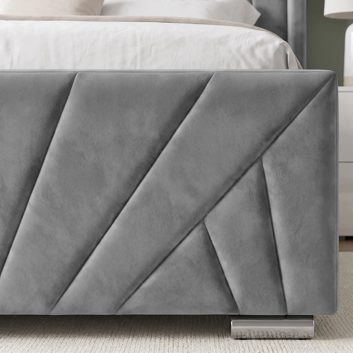 [King | Grey] close-up of a gray upholstered bed frame corner with geometric channel tufting and a metallic footboard support, shown in a bedroom setting