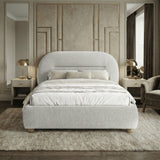 Front view of the king size grey upholstered bed frame in a modern room setting with natural light