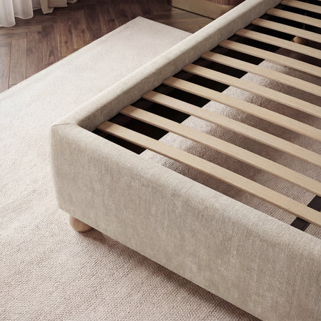 Close view of evenly spaced wooden slats designed to distribute mattress weight with beige upholstered footboard