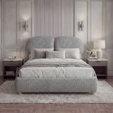 Front-facing grey bed frame in king size, evenly arranged pillows, and soft wall lighting, creating a balanced interior