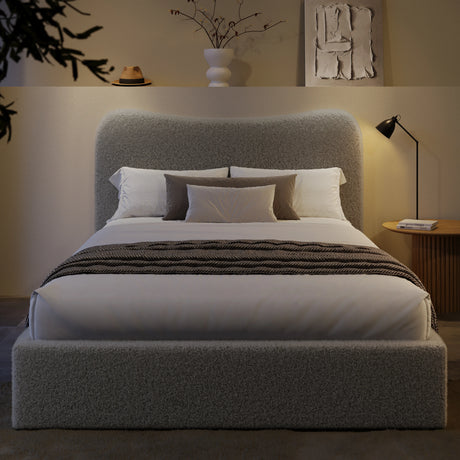 Curved headboard king size ottoman bed frame in boucle fabric with hidden under-bed storage. Stylish platform bed frame in soft grey, ideal for modern bedrooms.