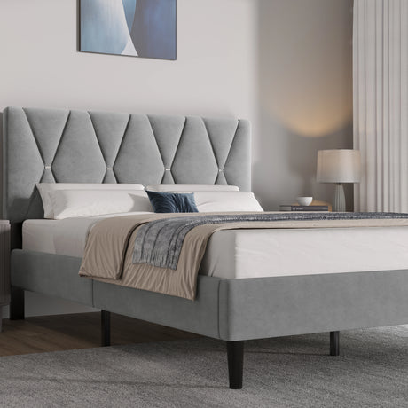 Grey upholstered bed with tufted headboard in a bedroom setting.