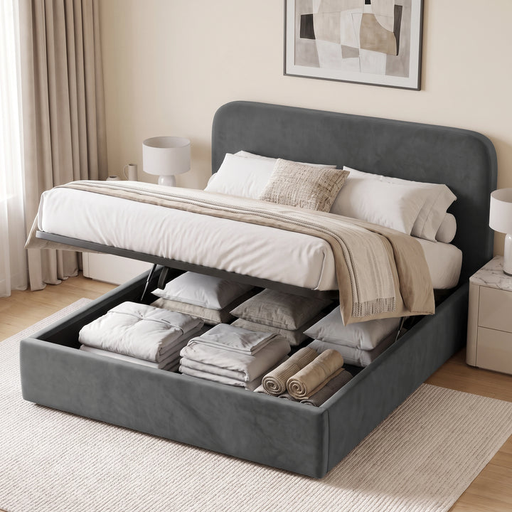 [King| Grey] upholstered lift-up storage bed with the mattress raised, showing neatly folded bedding and pillows in the open storage