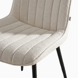 [Beige] Kyvon close-up of beige upholstered fabric vertical chair seat with black metal legs