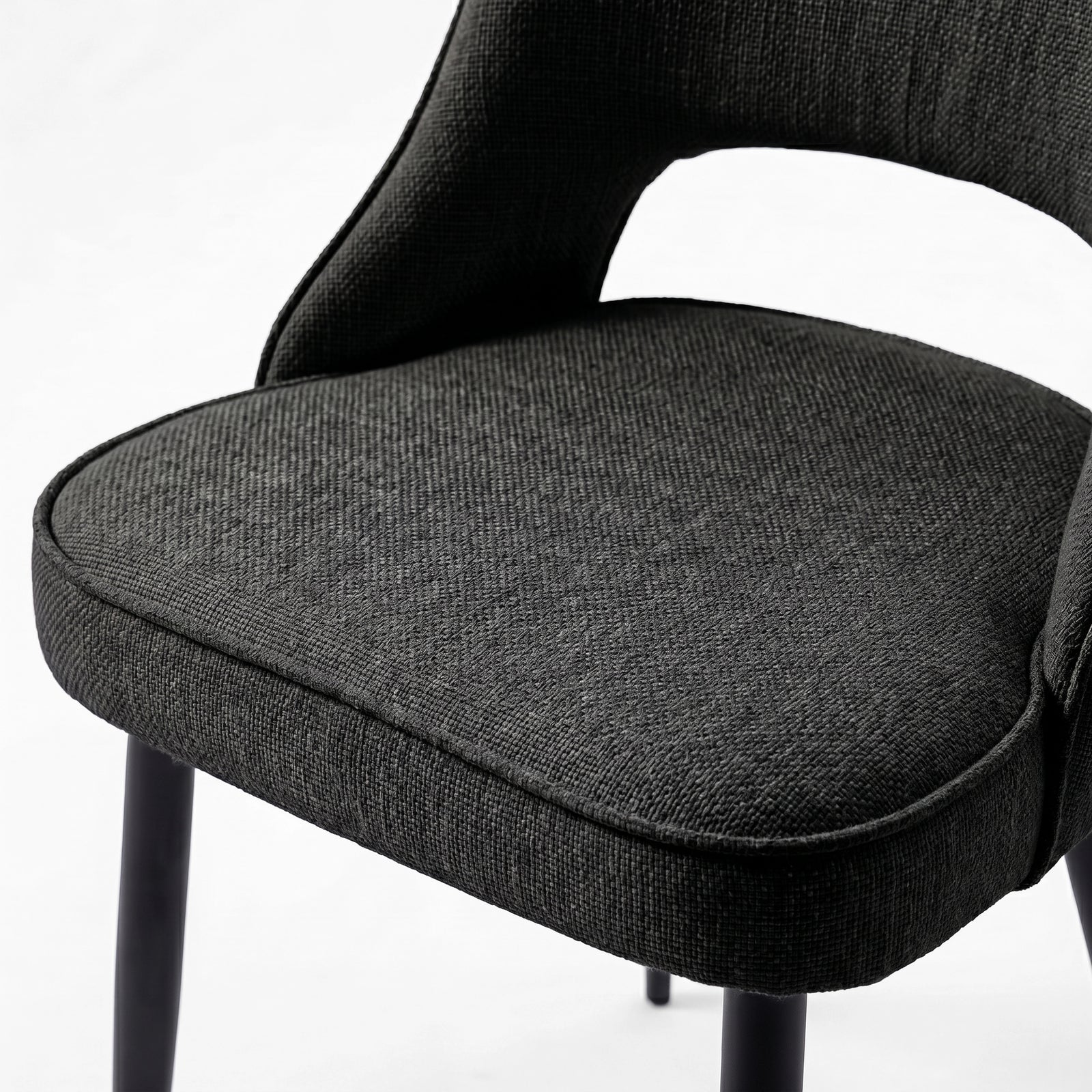 [Black | Clear] Close-up of Kyvon 4-seater black upholstered fabric comfy curve chair seat with black metal legs
