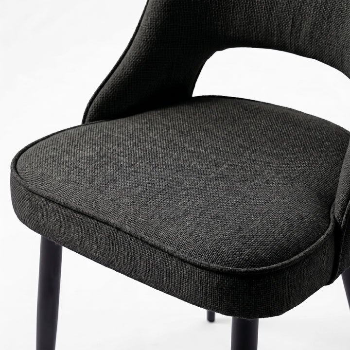 [Black | Clear] Close-up of Kyvon 4-seater black upholstered fabric comfy curve chair seat with black metal legs