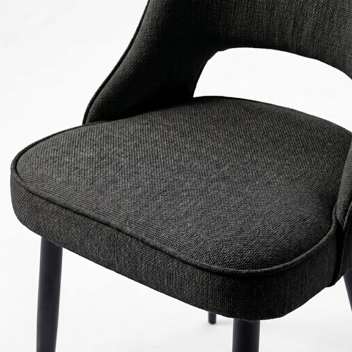[Black | Tinted] Close-up of the 4 seater Kyvon black upholstered fabric comfy chair seat with black metal legs