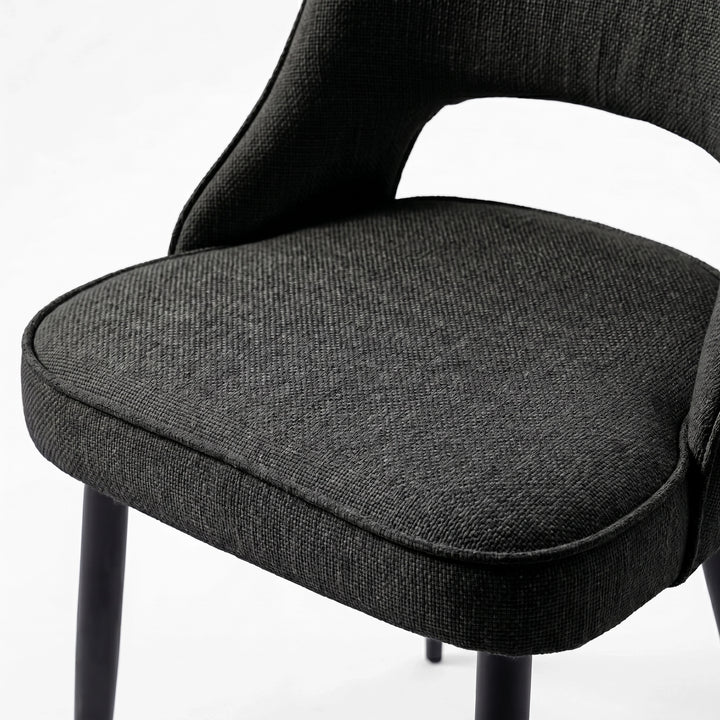 [Black | Tinted] Close-up of the 4 seater Kyvon black upholstered fabric comfy chair seat with black metal legs